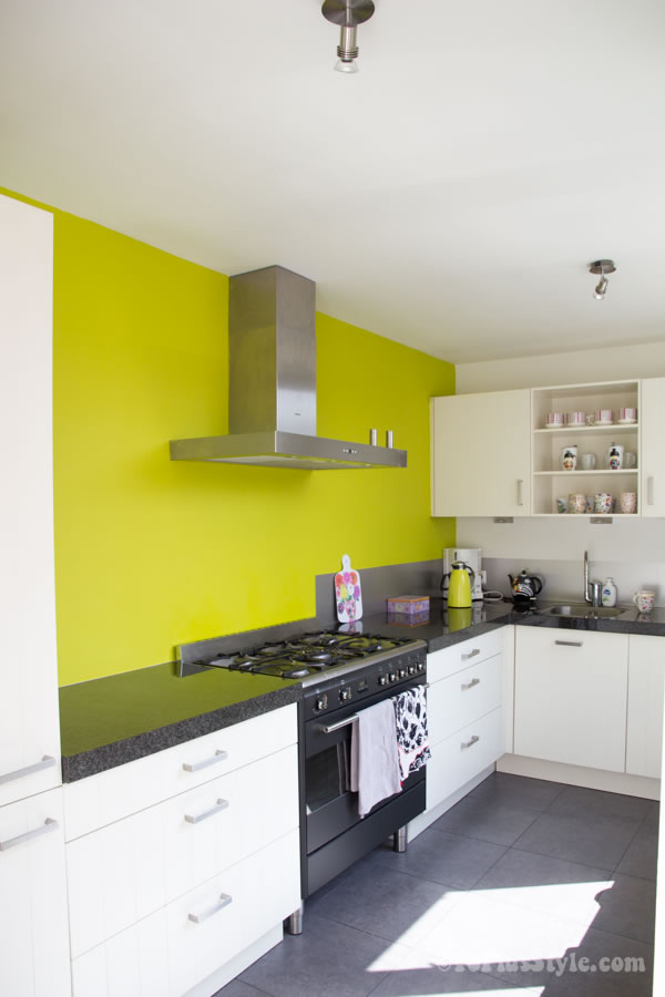 White kitchen with lime green wall | 40plusstyle.com