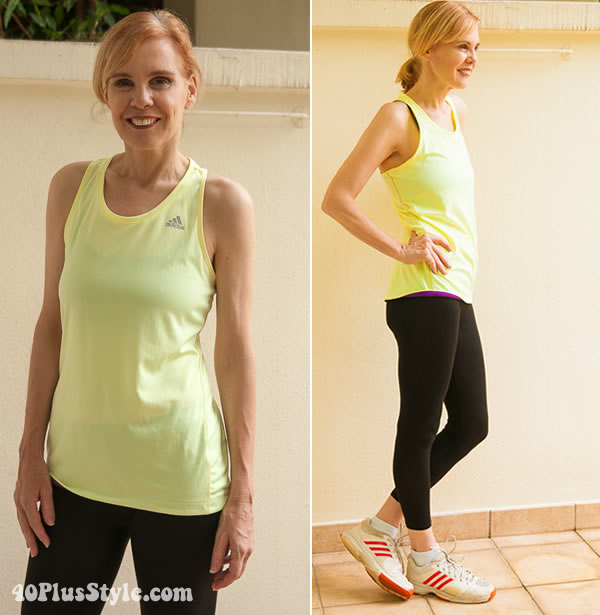 Fitness clothes for women - Sylvia wears a yellow top and black leggings | 40plusstyle.com