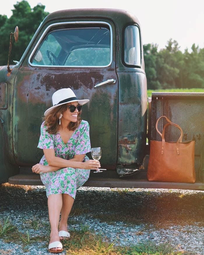 Carelia wearing floral dress and sun hat | 40plusstyle.com