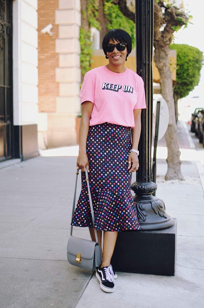 Kim wearing a pin statement shirt and sneakers | 40plusstyle.com