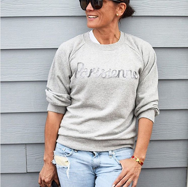Casual outfit idea for women over 40: Gray sweater and bleached jeans | 40plusstyle.com