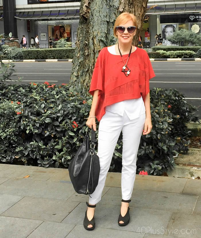 Wearing an asymmetrical top with white jeans | 40plusstyle.com