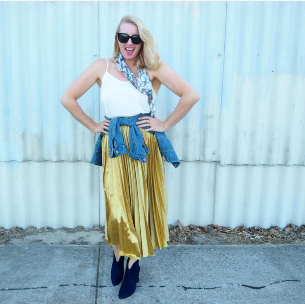Long gold pleated skirt with a denim jacket | 40plusstyle.com