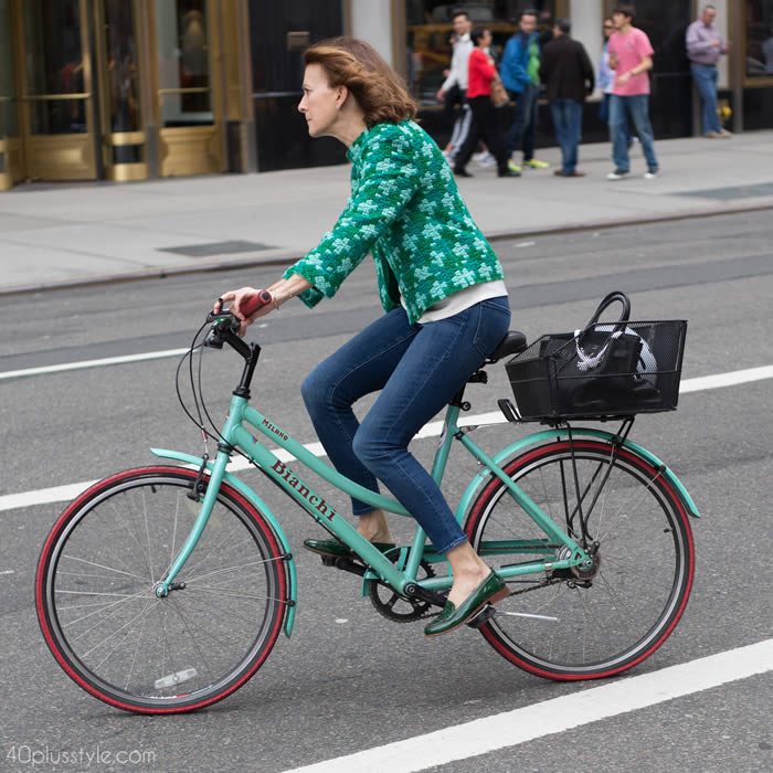 Getting noticed on a bike with a chic green jacket | 40plusstyle.com