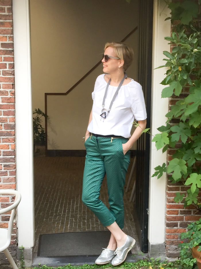 Printed green pants with white top and silver brogues | 40plusstyle.com
