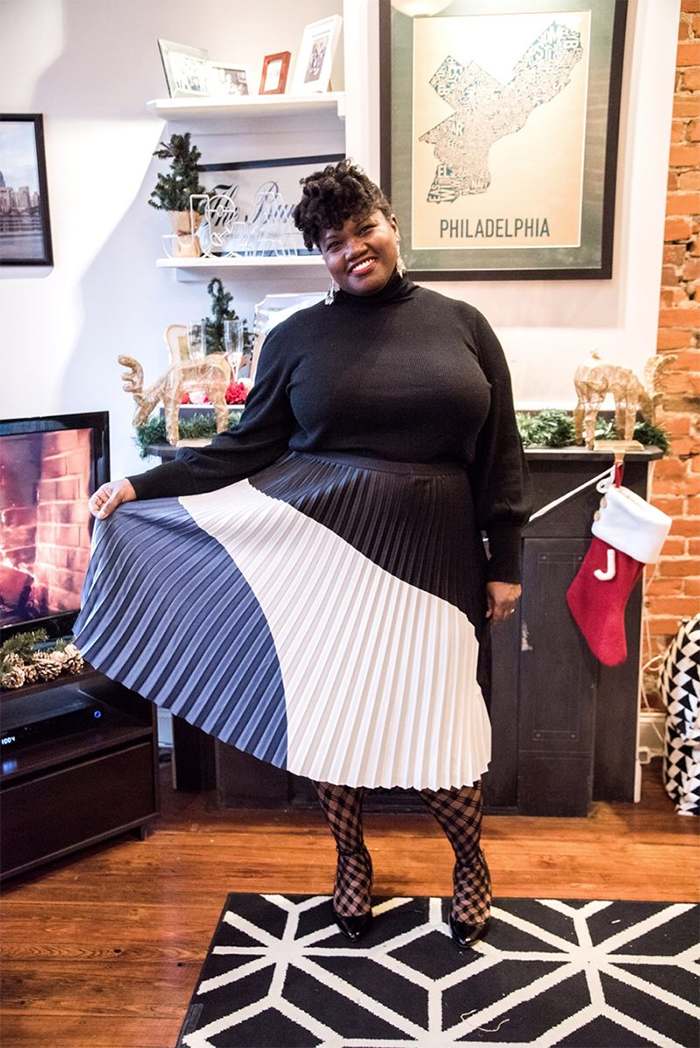 Georgette from Grown and Curvy Women is wearing Black Sweatshirt and Pleated Skirt | fashion over 40 | 40plusstyle
