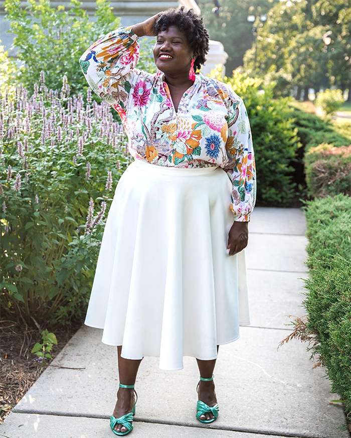 Georgette from Grown and Curvy Women is wearing Floral Long Sleeve Blouse with White Skirt and Green Strap Sandals | fashion over 40 | 40plusstyle