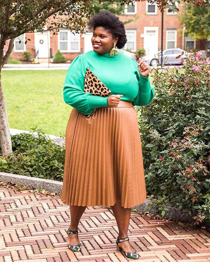 Georgette from Grown and Curvy Women is wearing Green Sweatshirt with Nude Pleated Skirt and Leopard skin Bag | fashion over 40 | 40plusstyle