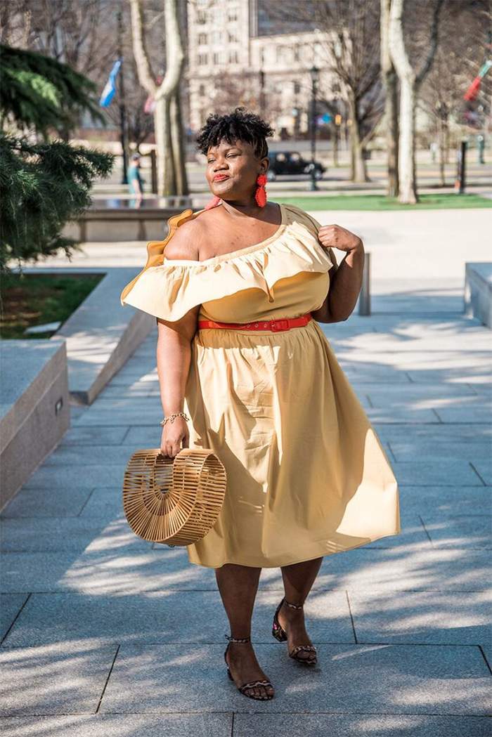 Georgette from Grown and Curvy Women is wearing Off shoulder yellow belted dress with Arc Bamboo bag and Red Earrings | fashion over 40 | 40plusstyle