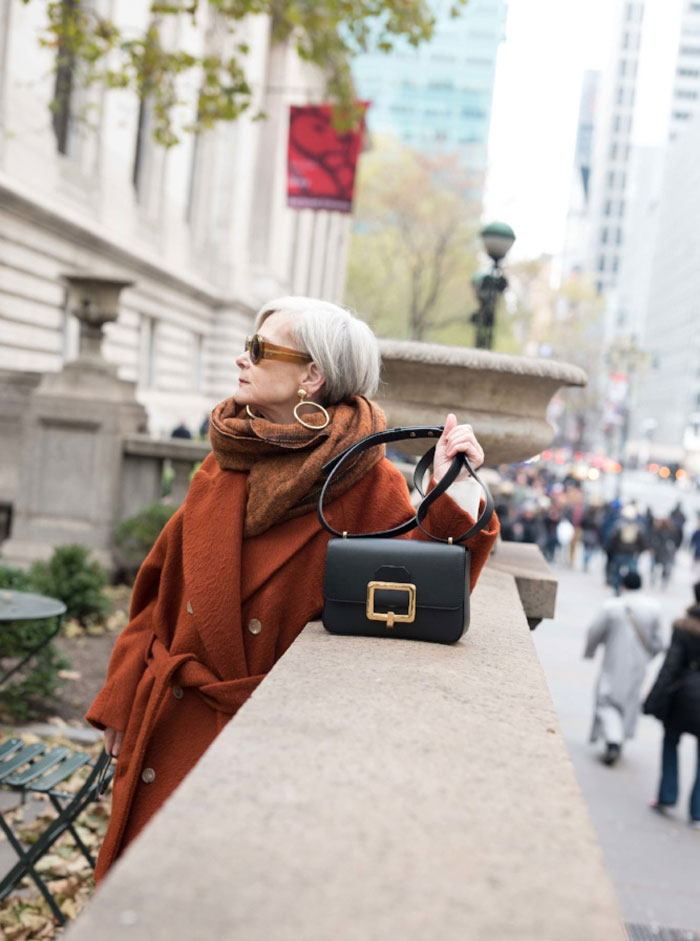Accidental Icon Wearing Rust Trench Coat with Bag | 40plusstyle.com