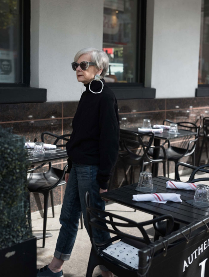 Accidental Icon Wearing Statement Earrings and Black Turtleneck Sweater | 40plusstyle.com