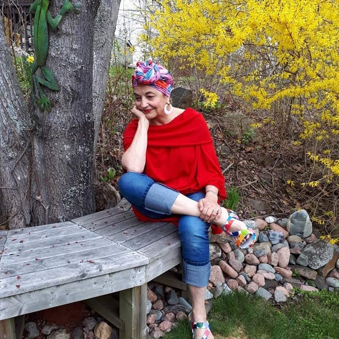 Terrie wearing a red top, jeans with head wrap | 40plusstyle.com