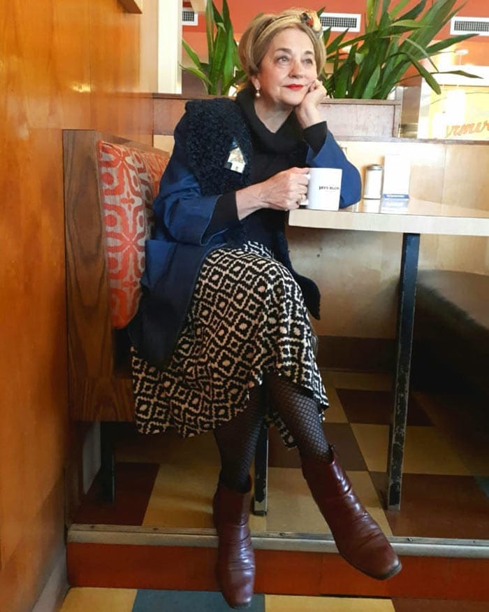 Terrie wearing coat, printed skirt with tights and booties| 40plusstyle.com
