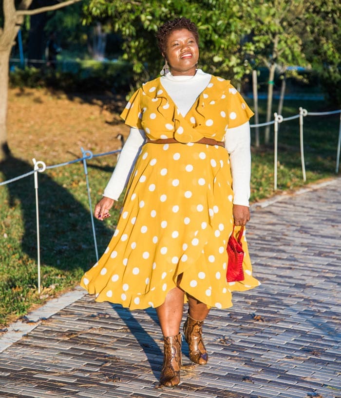 Georgette wearing a sweater layered under a ruffled midi dress | 40plusstyle.com