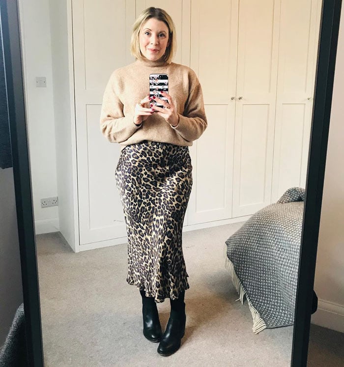 a beige sweater with an animal print skirt | 40plusstyle.com