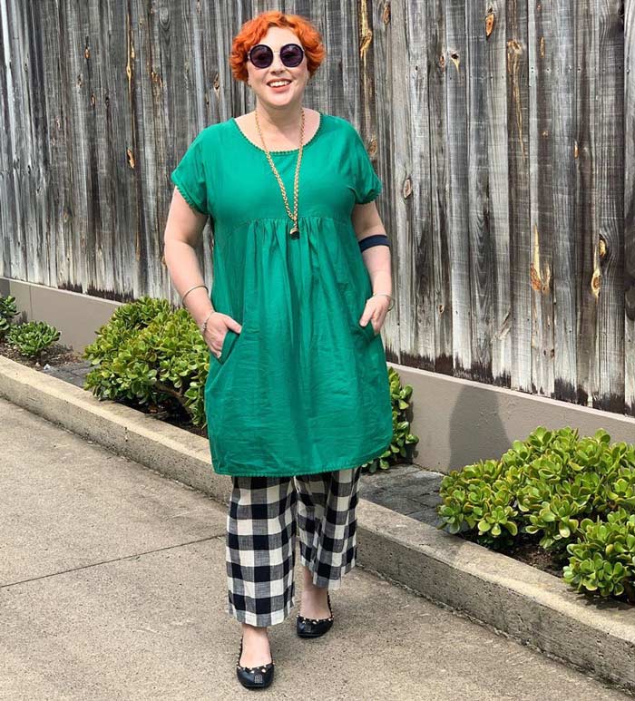 wearing a green dress over check pants | 40plusstyle.com