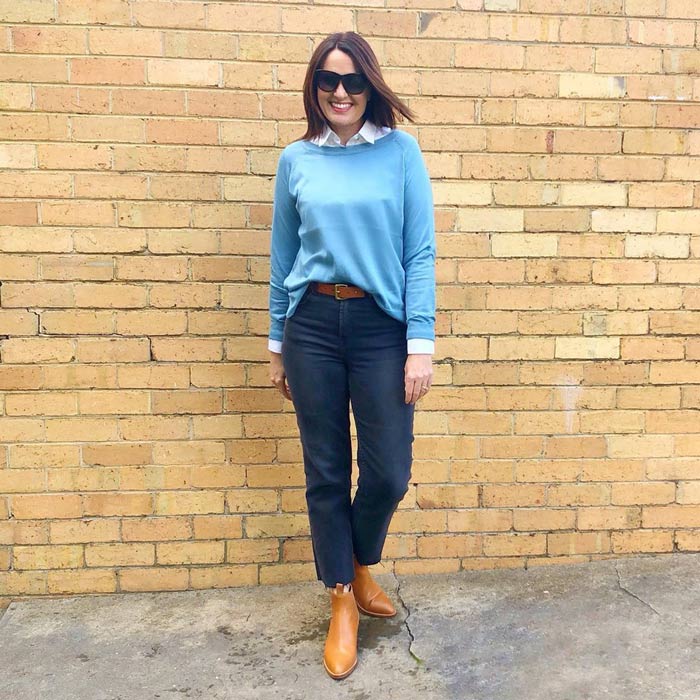 Layering a shirt and sweater worn with jeans and booties | 40plusstyle.com