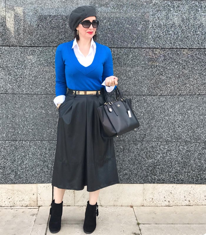 Layering a shirt and sweater worn with skirt and booties | 40plusstyle.com