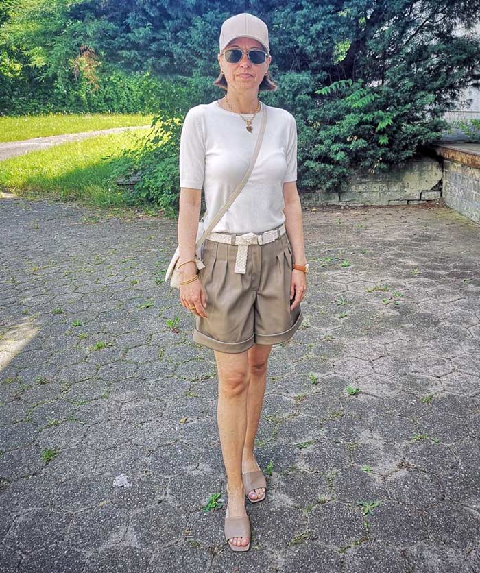 Chris wears her white tee with shorts and neutral accessories | 40plusstyle.com