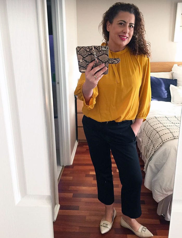 Fee wears smart loafers, pants and a yellow blouse | 40plusstyle.com