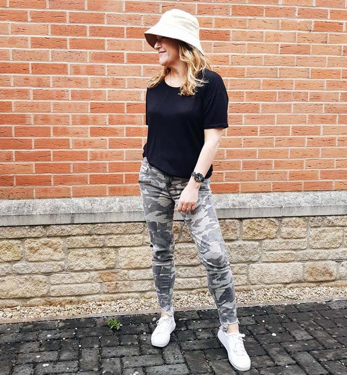 travel clothes for women - Gail wearing utility cargo pants and a black t-shirt | 40plusstyle.com