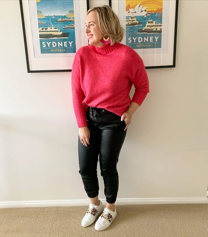 How to wear pink - Kylie wears a pink sweater and earrings | 40plusstyle.com