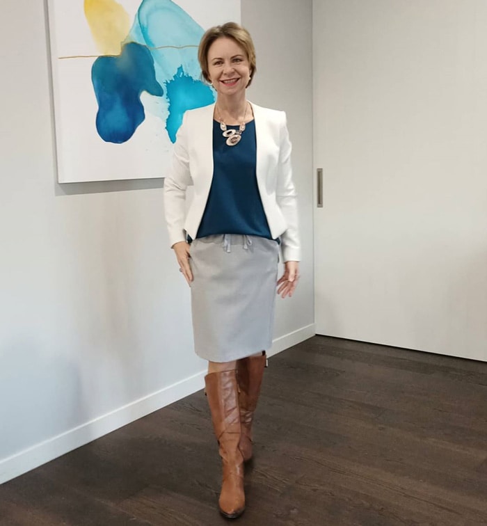 Wearing knee-high boots for work - Rachel wears boots with her pencil skirt | 40plusstyle.com