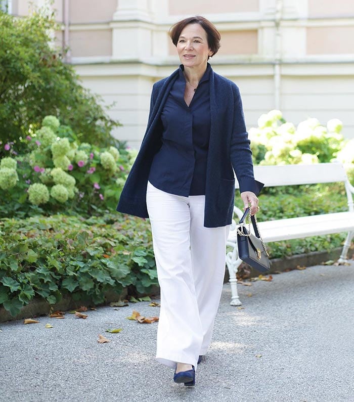 Annette wearing a navy sweater with white pants | 40plusstyle.com