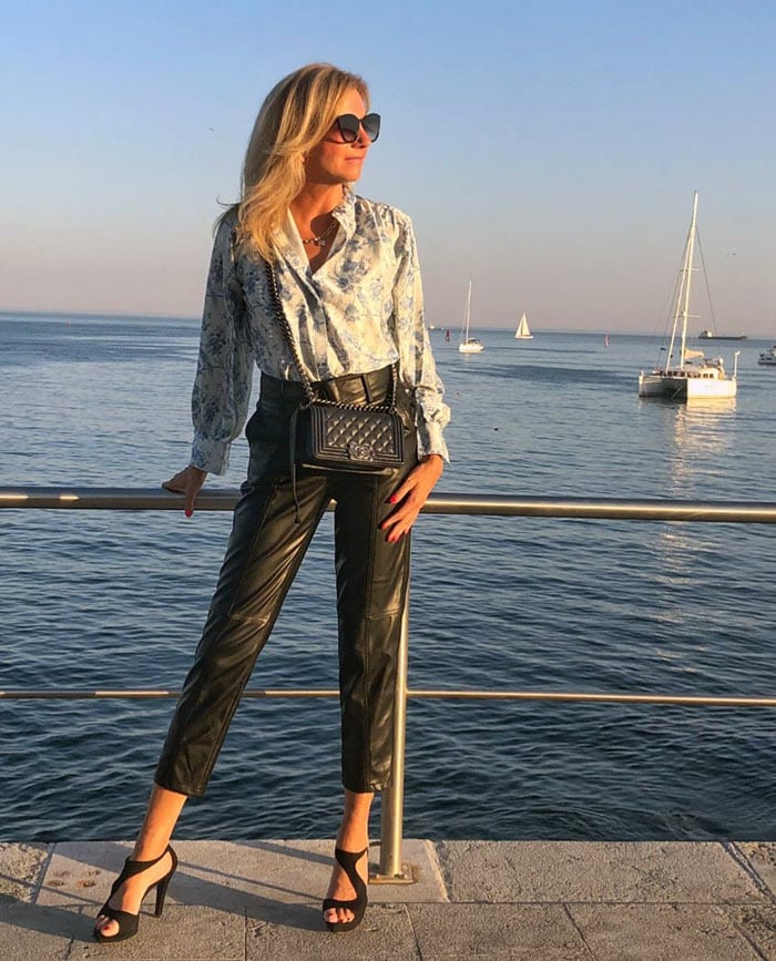 Elke wearing a print blouse and leather pants | 40plusstyle.com