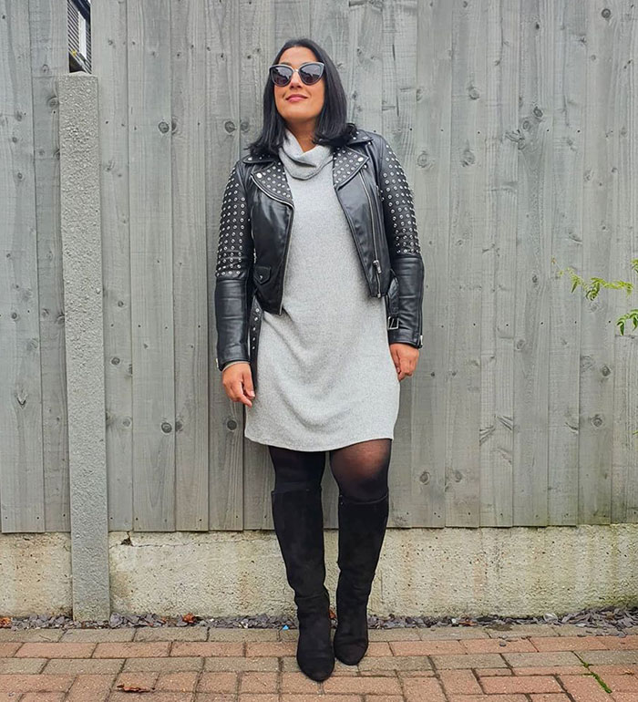 Jas wearing a winter sweater dress with a moto jacket and boots | 40plusstyle.com