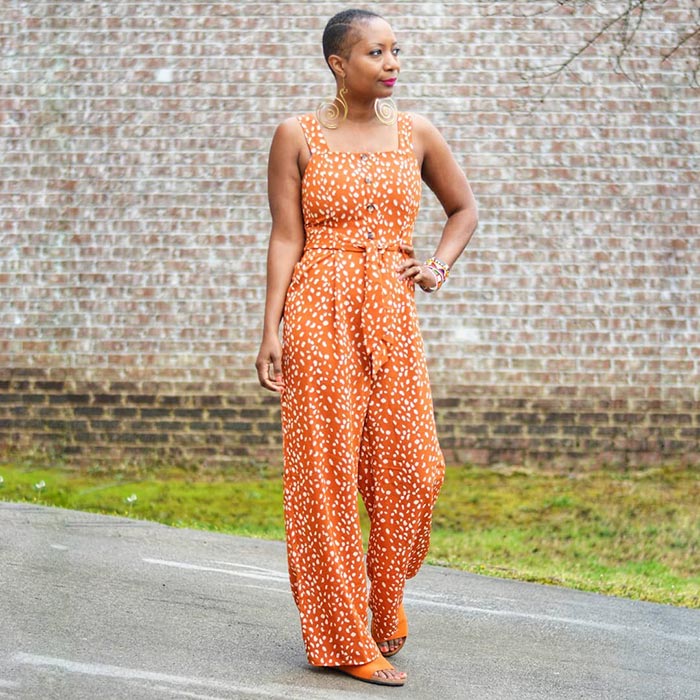 Summer jumpsuits for women - Troy wears an orange and white jumpsuit | 40plusstyle.com