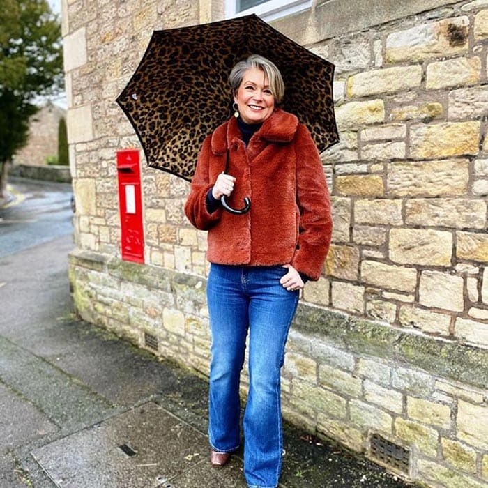 Rainy day outfits - Nikki carries an animal print umbrella | 40plusstyle.com