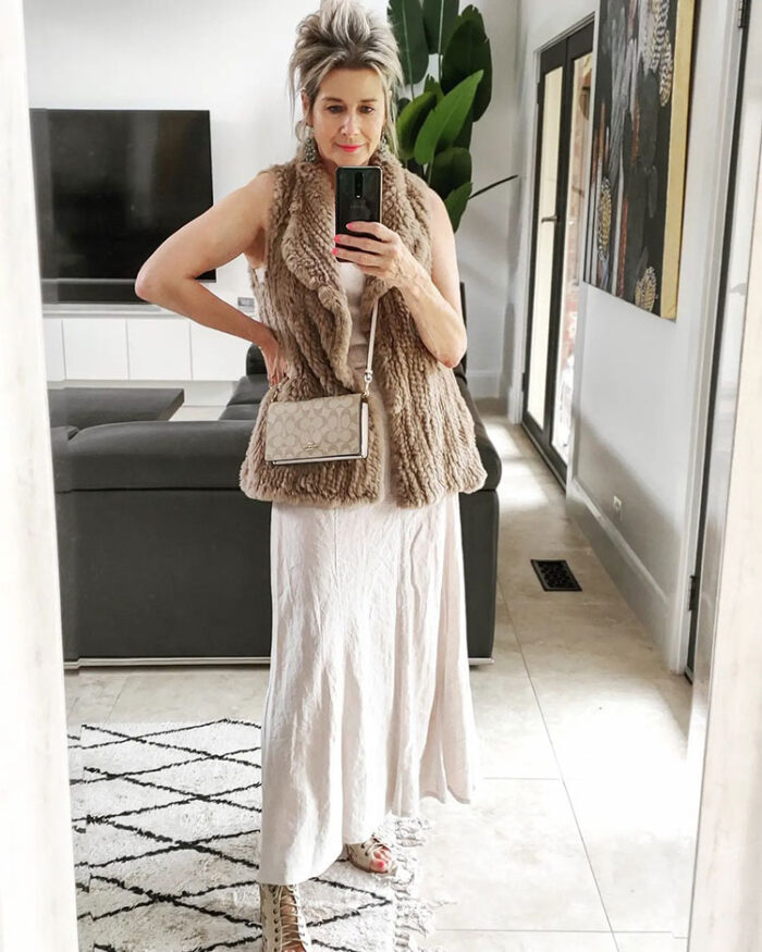 NYE outfits - Suzie in a faux fur vest and maxi dress | 40plusstyle.com