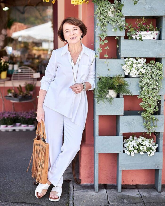 Clothes for older women - Annette in an asymmetric blouse, pants and sandals | 40plusstyle.com