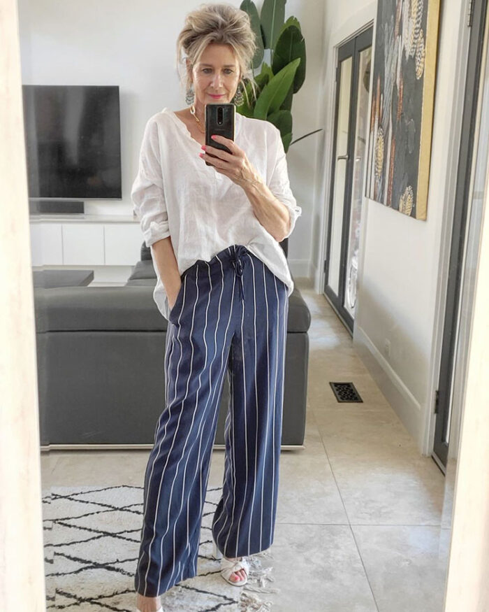 Suzie in striped pants, white top and heels | 40plusstyle.com