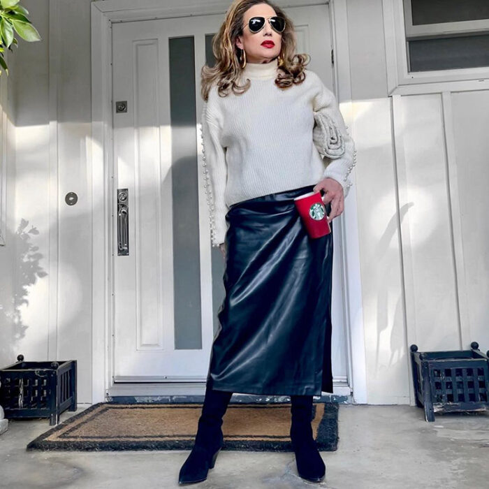 Clothes for older women - Madelyn in a pearl-sleeve sweater, leather skirt and boots | 40plusstyle.com