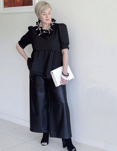Deborah gets an edgy style with her leather skirt and peep-toe booties | 40plusstyle.com