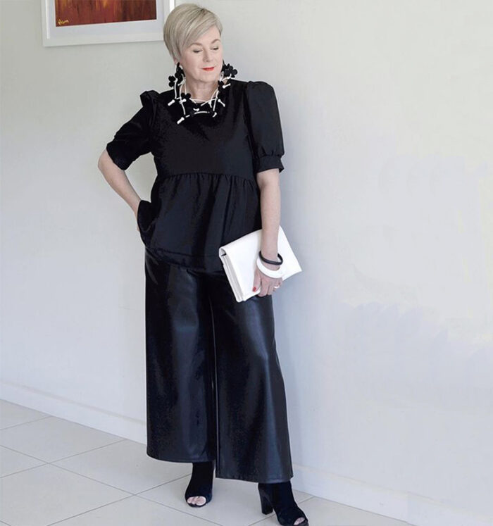 Deborah gets an edgy style with her leather skirt and peep-toe booties | 40plusstyle.com
