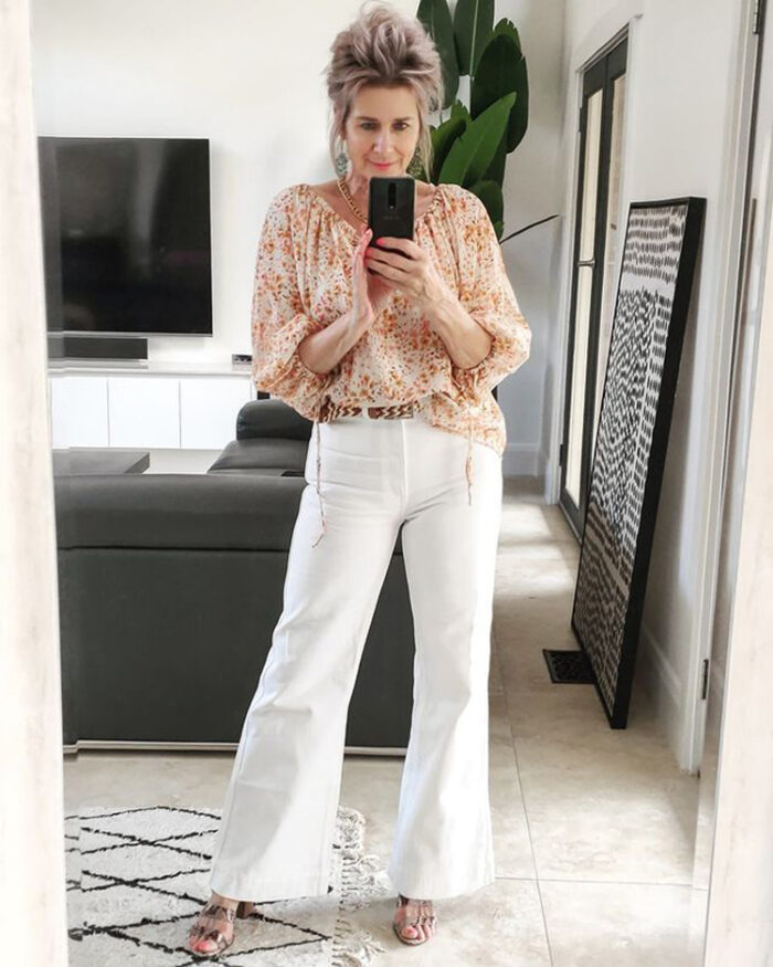 white flare jeans look great with a tucked in blouse | 40plusstyle.com