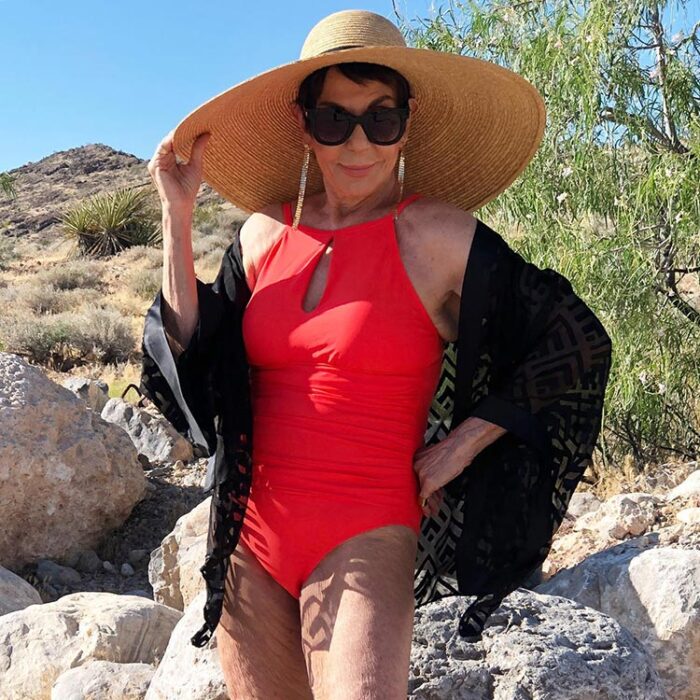Dorrie in a red swimsuit and black beach cover up | 40plusstyle.com