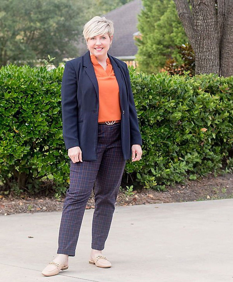 Fonda in a navy blazer and orange top | 40plusstyle.com