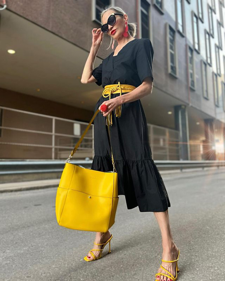 Jamie wears her black dress with yellow accessories | 40plusstyle.com