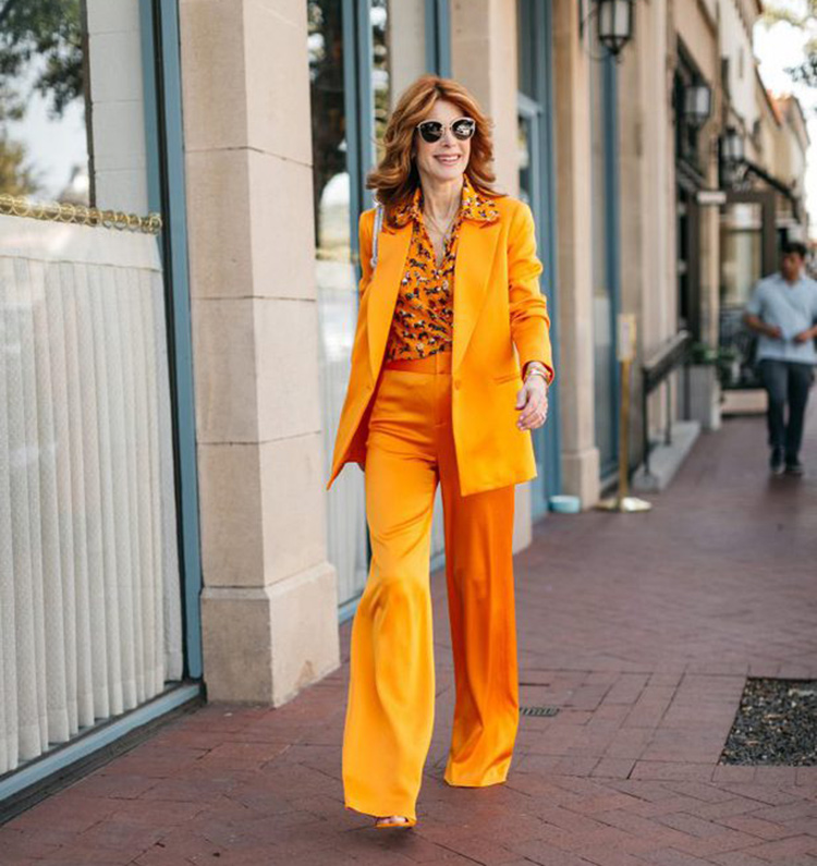 Best suits for women - Cathy wears an orange suit | 40plusstyle.com