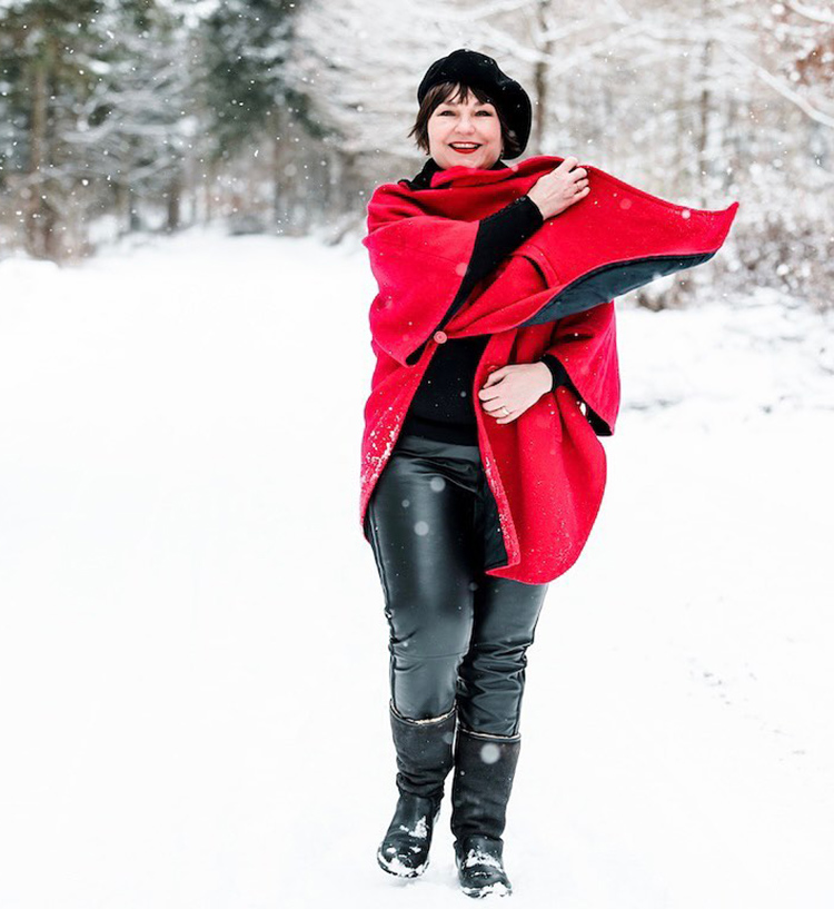 Best wide calf boots for women - Susanne wears black boots and red coat | 40plusstyle.com