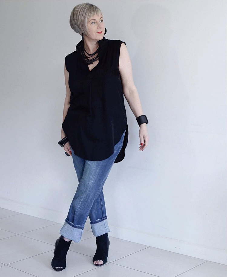 Deborah wears a black top and jeans | 40plusstyle.com