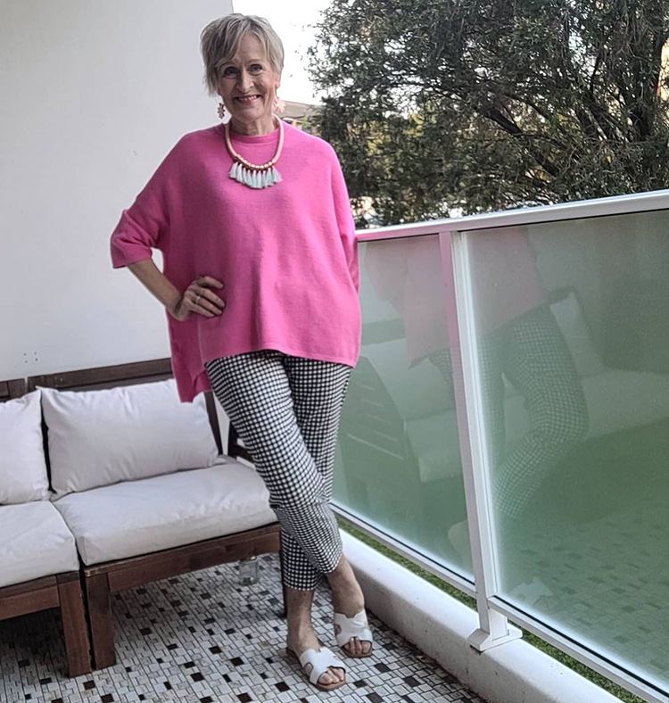 How to hide your belly - Barb in a loose pink sweater | 40plusstyle.com