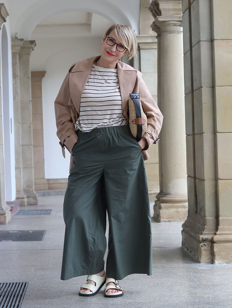 Claudia in striped shirt, trench coat, wide pants and sandals | 40plusstyle.com