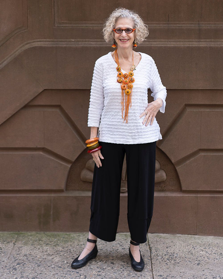 Dayle wears a pair of ankle length pants and a white top | 40plusstyle.com