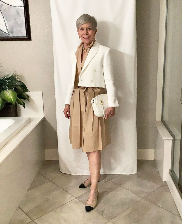 Summer dresses for women over 40 - Eileen wears a beige dress and white jacket | 40plusstyle.com