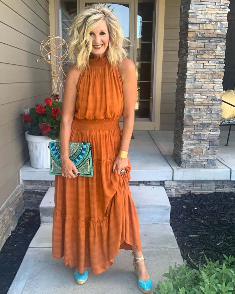 Melanie wears an orange dress with turquoise accessories | 40plusstyle.com